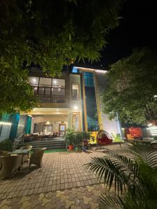 a large building with a patio at night at Kaashi Flora (Full Villa - 5 Bedrooms) in Varanasi