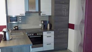 a kitchen with a sink and a stove top oven at BIENE`S Ferientraum in Reit im Winkl