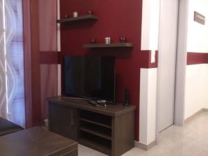 a living room with a flat screen tv on a stand at BIENE`S Ferientraum in Reit im Winkl