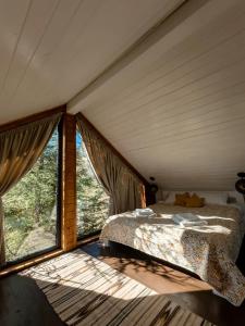 a bedroom with a bed and a large window at Chili Shale in Yablunytsya