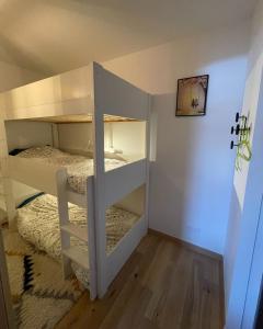 a room with two bunk beds in a room at Le Roc in Saint-Jean-d'Aulps