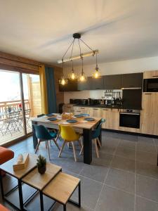 a kitchen with a table and chairs and a dining room at Le Roc in Saint-Jean-d'Aulps