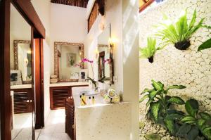 a bathroom with a sink and a mirror at Villa Domus De Janas in Seminyak +24 photos