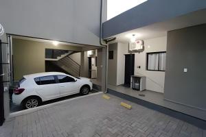 ein weißes Auto, das in einer Garage geparkt ist in der Unterkunft Xavi Studio - Proximo ao Boulevard Shopping, Av Nacoes Unidas e Nuno de Assis. in Bauru