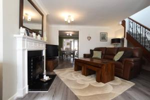 a living room with a couch and a fireplace at Spacious Family Home Sleeps 6 in Alverstoke