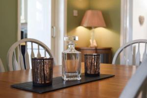 a glass perfume bottle on a black tray on a table at Spacious Family Home Sleeps 6 in Alverstoke