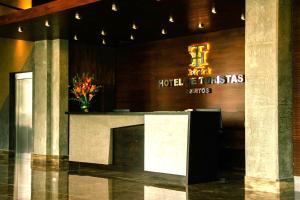 a hotel lobby with a reception desk and a sign at Hotel de Turistas Iquitos in Iquitos