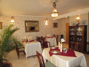 a dining room with tables and chairs in a restaurant at Pension Dinu Residence in Timişoara
