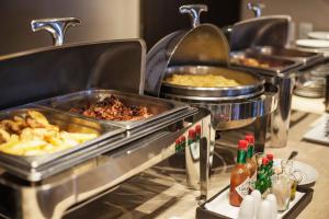 a buffet line with different types of food in trays at Hotel 620 in Hagerstown
