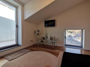 a room with a bed and a tv and a window at WelcomeBuddy - Villa Wave N'Sea - Beachfront in Mosteiros