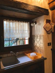a kitchen with a sink and a window at Appartamento "Verdjats" in Challand Saint Anselme