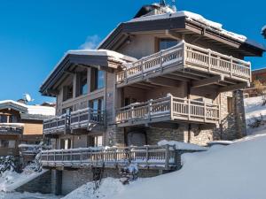 un grand bâtiment avec de la neige au sol dans l'établissement Chalet de luxe avec jacuzzi et garage à Courchevel - FR-1-563-30, à Courchevel