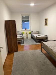 a room with two beds and a window at Apartment bei Michael Bochum in Bochum