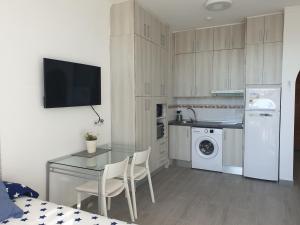 a kitchen with a table and a table and a dining room at Carihuela Park Palace Studio in Torremolinos