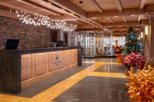 a lobby with a christmas tree and a reception desk at Eurostars La Pleta in Baqueira-Beret +165 photos