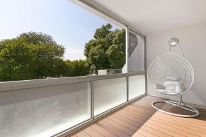 an empty room with a chair and a large window at Gordonia 10 by HostAgents in Gordonʼs Bay