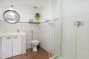a bathroom with a toilet and a glass shower at Gordonia 10 by HostAgents in Gordonʼs Bay