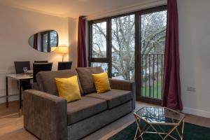 a living room with a couch and a table at Deluxe North Central London Apartment in London