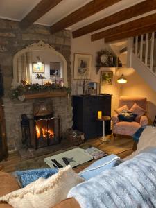 a living room with a fireplace and a couch at Hideaway Cottage in Whitby