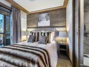 a bedroom with a large bed with a wooden wall at Appartement Courchevel 1550, 4 pièces, 8 personnes - FR-1-562-19 in Courchevel