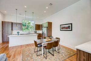 a kitchen and dining room with a table and chairs at 4 Story Modern Home Sleeps 10 - DT Views! in Houston