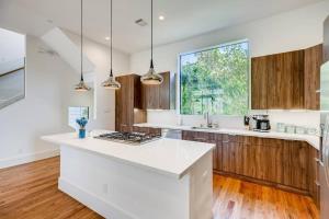 a kitchen with white counters and a large window at 4 Story Modern Home Sleeps 10 - DT Views! in Houston