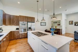 a kitchen with white cabinets and a counter top at 4 Story Modern Home Sleeps 10 - DT Views! in Houston