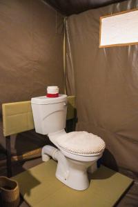 a bathroom with a toilet in a room at Olimba Mara Camp in Mara Simba