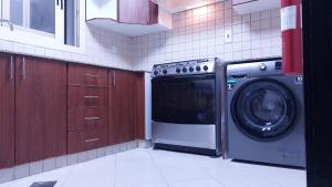 a kitchen with a washer and a washing machine at BEAUTIFUL VACATION HOME AT DUBAI BY MAUON TOURISM in Dubai