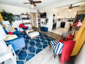 a living room with a blue couch and a blue rug at Nautical Retreat (Unit 5) in Galveston