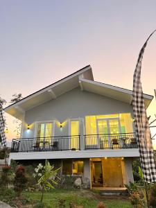 een huis met een veranda en een balkon bij One Ubud Village in Gunungpicung