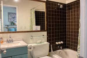 a bathroom with a toilet and a sink and a bath tub at Walk Everywhere at the Relaxing Val D Sol Condo in Sun Valley +15 photos