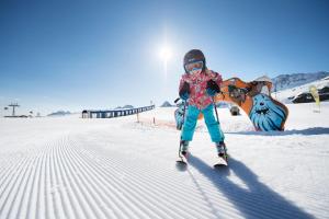 a young girl is skiing in the snow at Haus Gerlinde Danler in Neustift im Stubaital