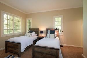 two beds in a room with two windows at Gimlet Family Home Close to Lift with Hot Tub! in Hailey