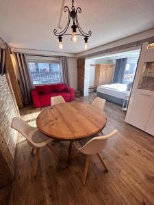 een woonkamer met een houten tafel en stoelen bij Casa Enrico in Oberjoch