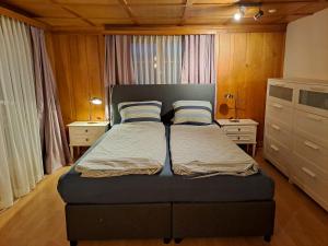 a bedroom with a bed with two pillows on it at Haus Dani Danis in Danis