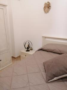 1 dormitorio con cama y pared blanca en ELISEA HOUSE MARIO PAGANO, en Oria