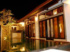 a building with windows and a sign in front of it at Villa Cantik Tresna in Seminyak