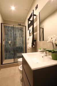 a bathroom with a toilet and a sink and a shower at Meyland suites centro in Milan +31 photos