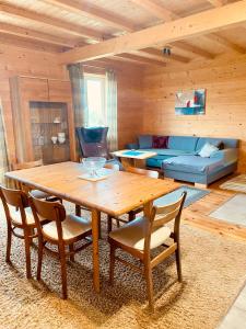 a living room with a wooden table and chairs at Holidayhome Juksty in Mrągowo