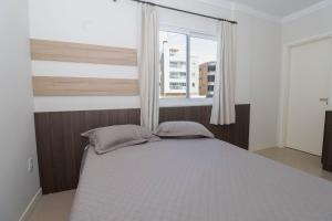 A bed or beds in a room at 377 - Belissimo apartamento na praia de Bombas
