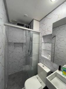 a bathroom with a shower and a toilet and a sink at Flat em Brasília - Park Sul in Brasilia