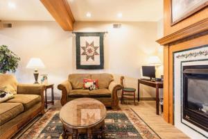 a living room with two couches and a fireplace at Lancaster Inn & Suites in Manheim