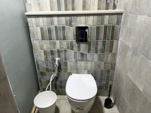 a small bathroom with a toilet and a sink at Downtown Inn Madaba in Madaba