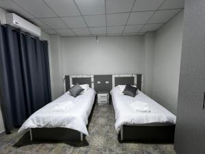 a room with two beds in a room at Downtown Inn Madaba in Madaba