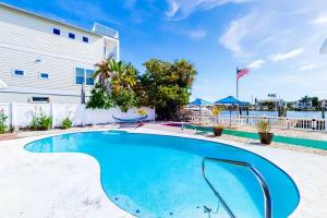 a swimming pool in front of a building at Private 3 bedroom waterfront Villa with pool in Clearwater Beach