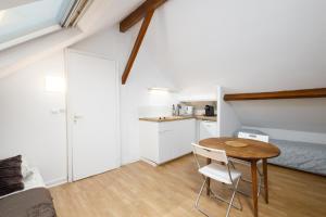 a small room with a table and a bed at Lovely apartment Deauville in Deauville +2 photos