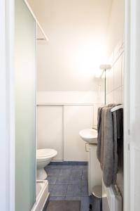 a bathroom with a toilet and a sink at Lovely apartment Deauville in Deauville