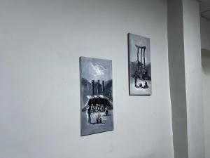 three pictures hanging on a wall in a museum at Downtown Inn Madaba in Madaba