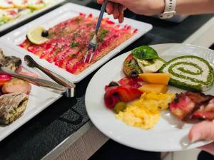 a table with two plates of food on it at FACTORY RESORT wellness & spa in Kołobrzeg